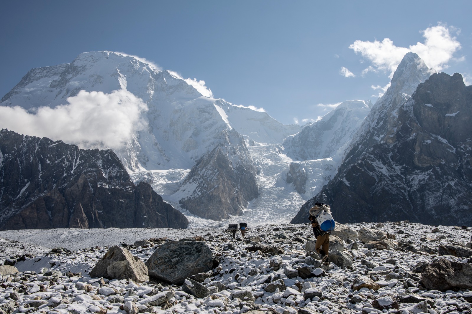 The rugged base of Broad Peak, surrounded by the towering peaks of the Karakoram, high-altitude rock climbing adventures.