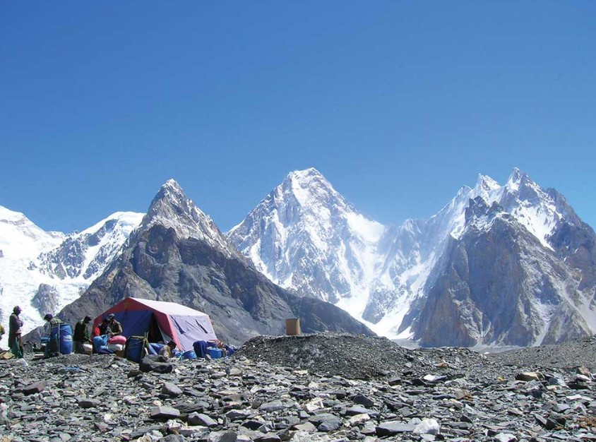Stunning view of Concordia with K2 and surrounding peaks towering under a clear blue sky.