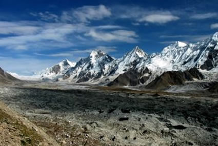 A stunning landscape of snowy mountains and rugged trails, showcasing the beauty of the Thalay La trekking route.